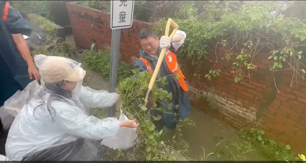何博文2日率領黨工及志工,前往台南市後壁區菁寮國小清理水溝淤泥與雜草進行救災工作。(圖/中天新聞)