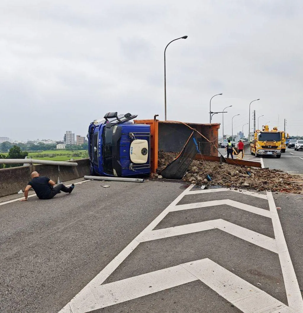 台66線發生砂石車翻覆事故，車體橫躺路面，砂石散落一地，司機爬出來驚魂未定。（圖／警方提供）