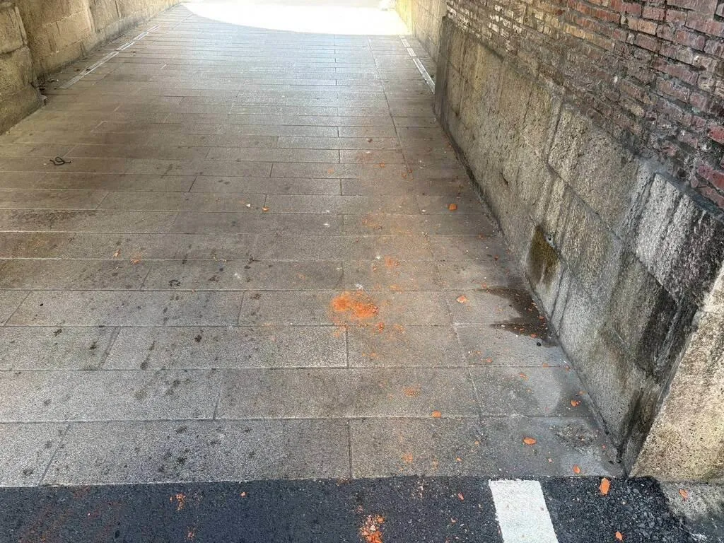 陳男3日晚間開車行經恆春西門城門時，不慎擦撞城牆，致牆面輕微擦損，地面也都是紅磚碎粒。（恆春警方提供）
