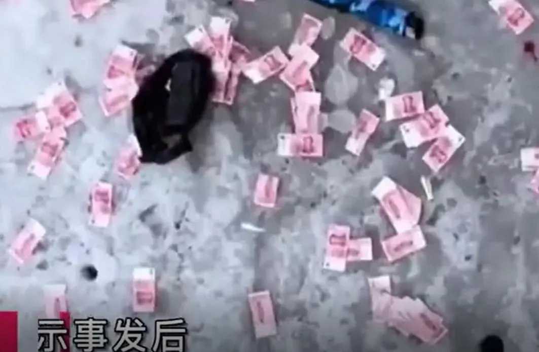 大量百元人民幣鈔票,灑落在結冰的河面上。(圖/翻攝新浪微博)