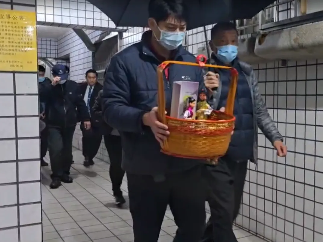 同樣身為消防員的弟弟詹庭豪手捧牌位緩步走出。（圖／翻攝畫面）