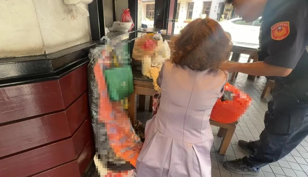 婦人長期佔著位子不走，已對店家生意造成妨礙，警方到場勸離。（圖／中天新聞）