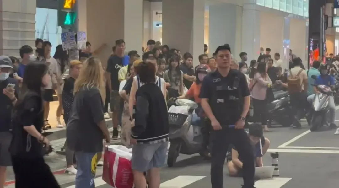 現場聚集眾多民眾圍觀，警方立即拉封鎖線，避免民眾遭落下的火舌給波及。（圖／中天新聞）