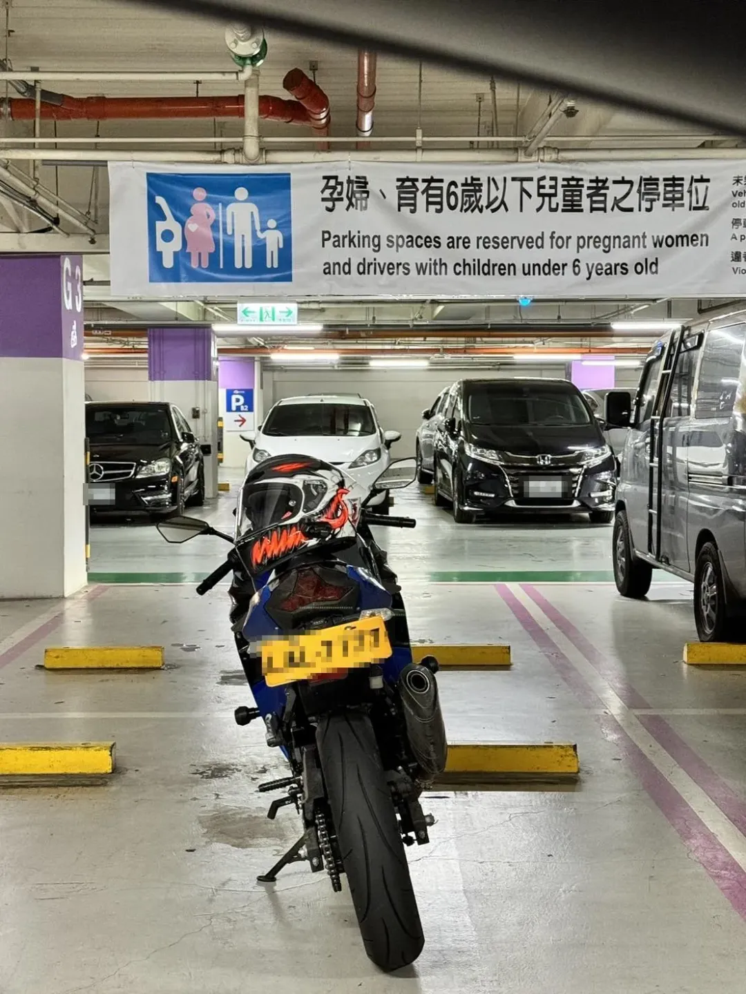 一台藍色大型重機利用側柱並將重機佔用停放婦幼停車格內。（圖／中天新聞）