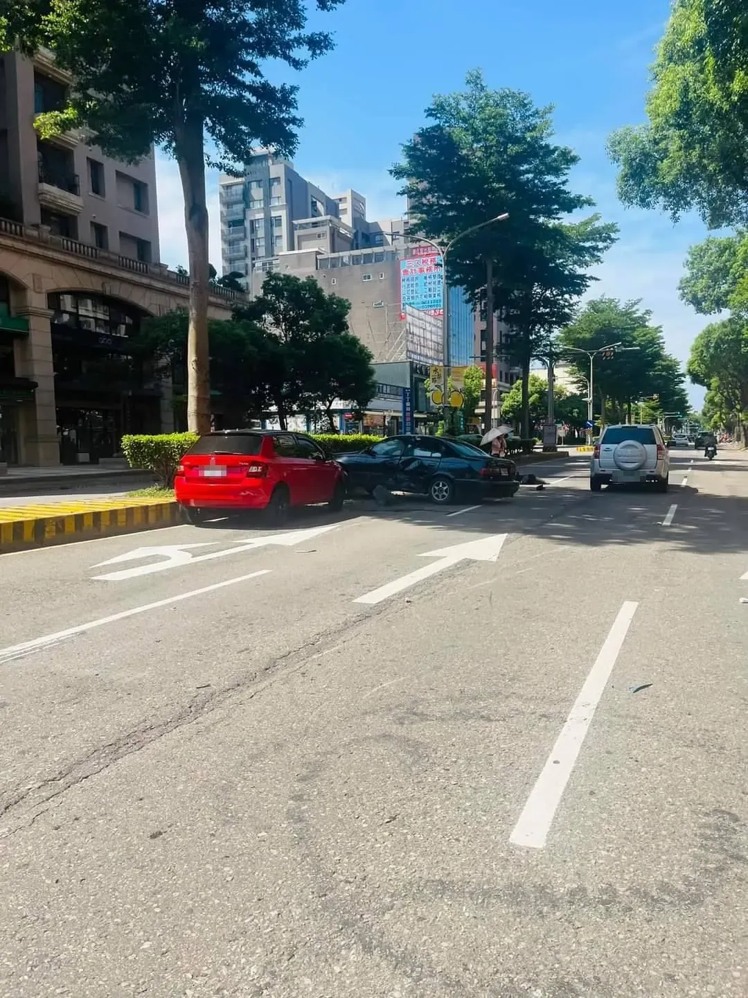 機車彷彿被炸開般，車殼零件散落一地，而其中一部汽車則撞上分隔島。（圖／翻攝自記者爆料網）