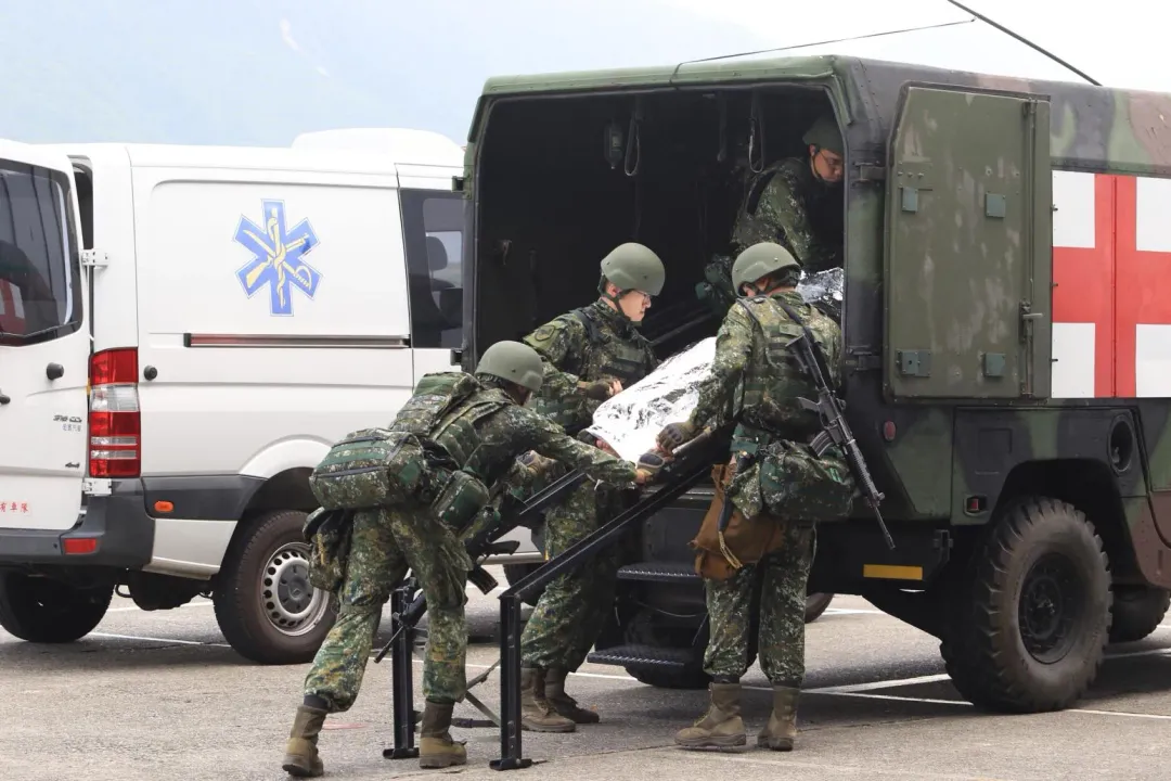 醫護官兵將後送傷患送上悍馬救護車。(圖/中天新聞,宋玉寧攝)