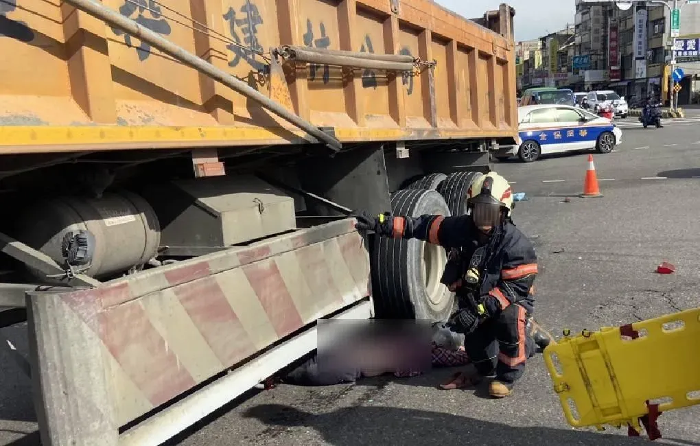 砂石車輾過電動機車,騎士被壓在車底。(圖/警方提供)