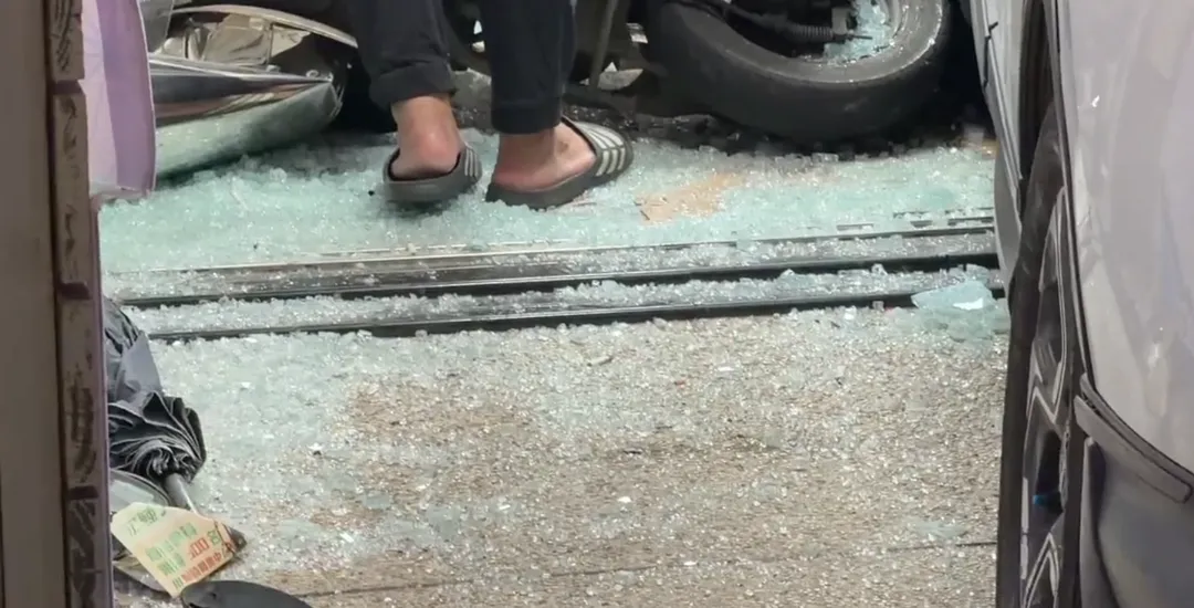 由於休旅車撞擊力道猛烈，導致鋁門框扭曲變形、玻璃破裂散落一地，屋內機台也受損。（圖/警方提供）