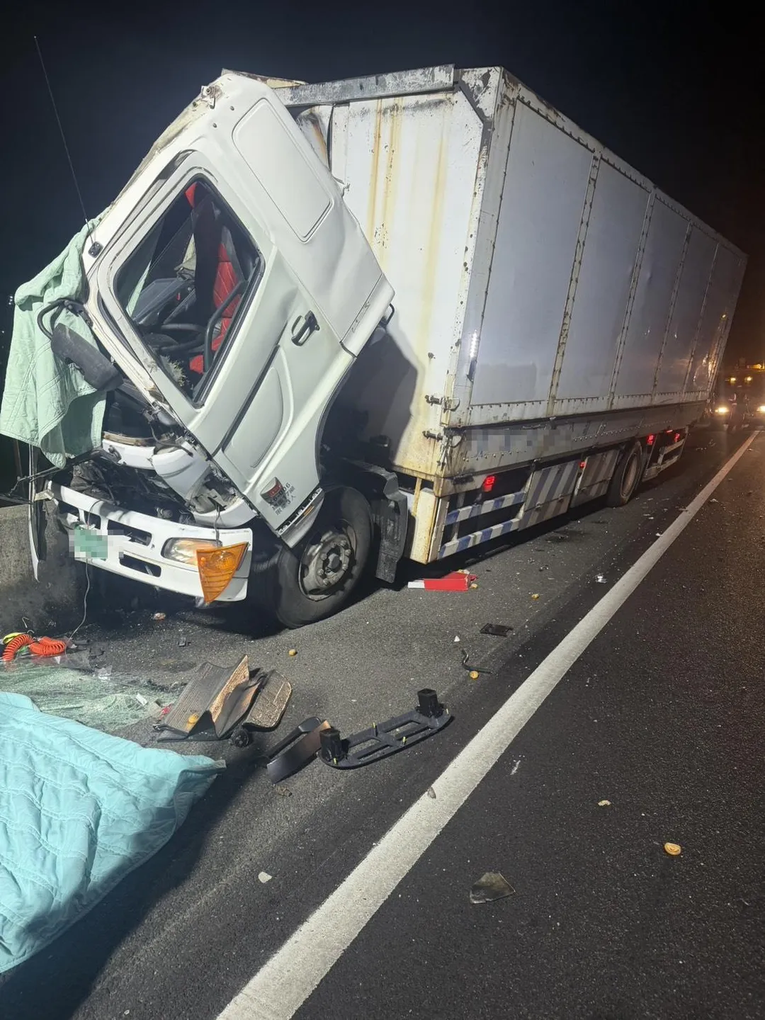 一輛營業大貨車不明原因失控,猛烈撞擊外側護欄與隔音牆,車頭嚴重毀損。(圖/翻攝畫面)