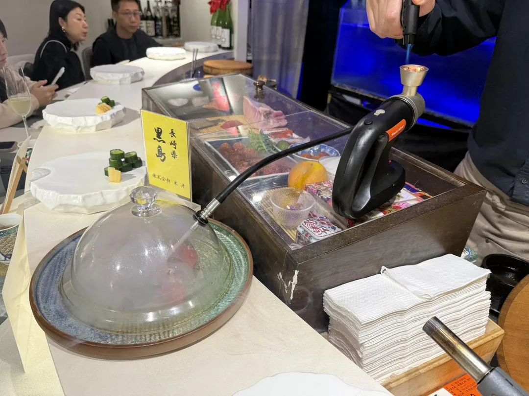 小灶內點燃蘋果木，用於現場煙燻黑鮪魚大腹肉。（圖／黃宏輝提供）