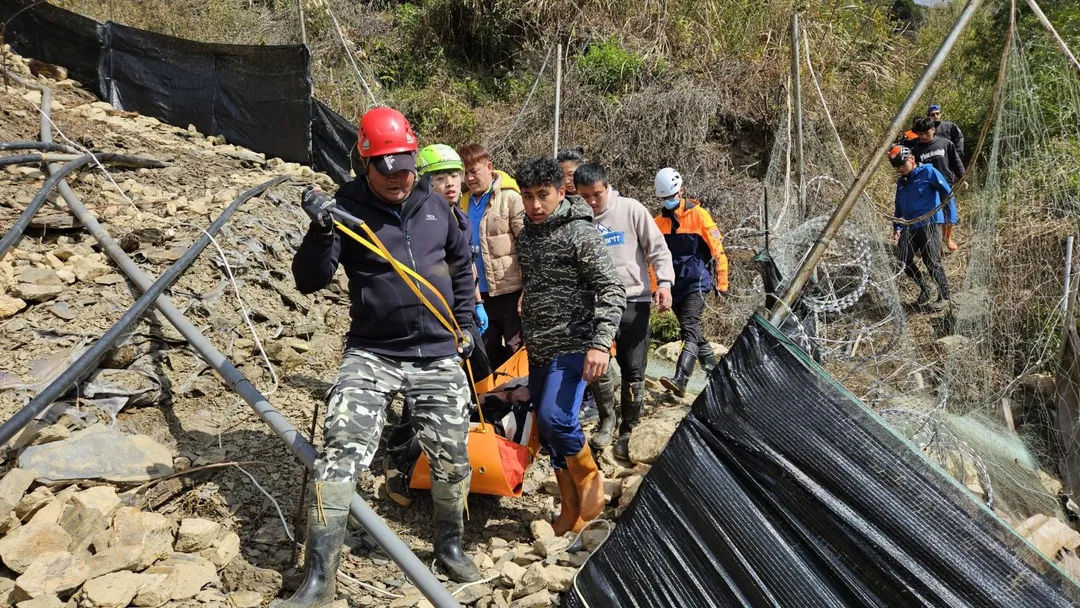救難人員和熱心民眾齊力將受困車頭的駕駛送上路面。（圖／神鷹搜救隊提供）