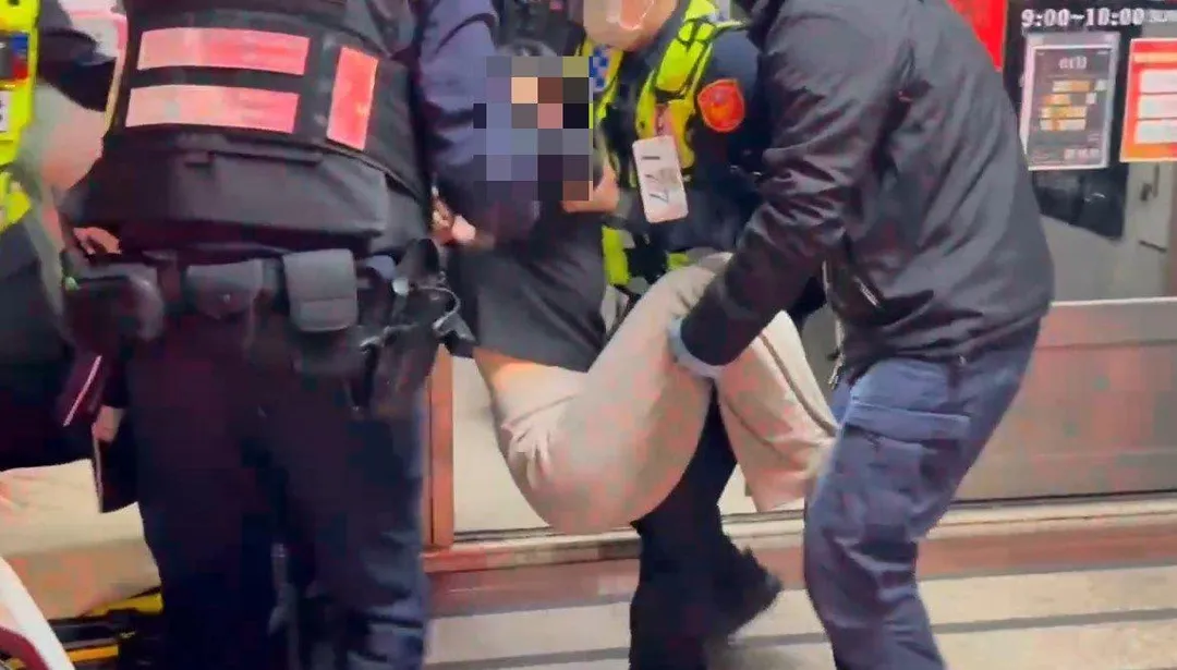 陳女情緒極度不穩，不肯配合救護，警方與消防醫護人員合力將陳女四肢固定。（圖／翻攝畫面）