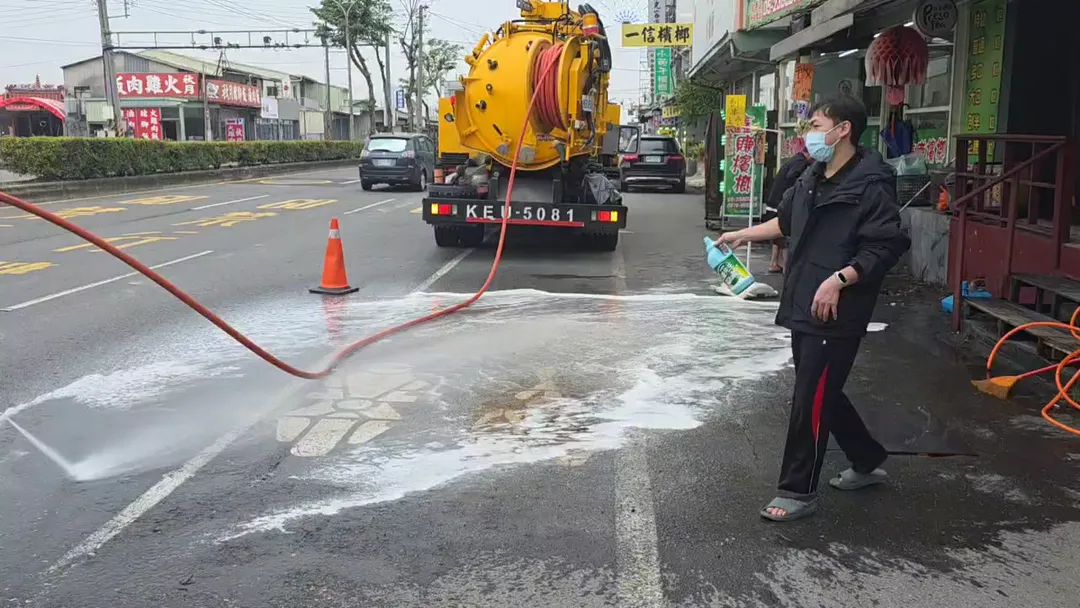 清潔人員出動高壓水槍清洗路面，血水流一整片讓人怵目驚心。（圖／中天新聞）