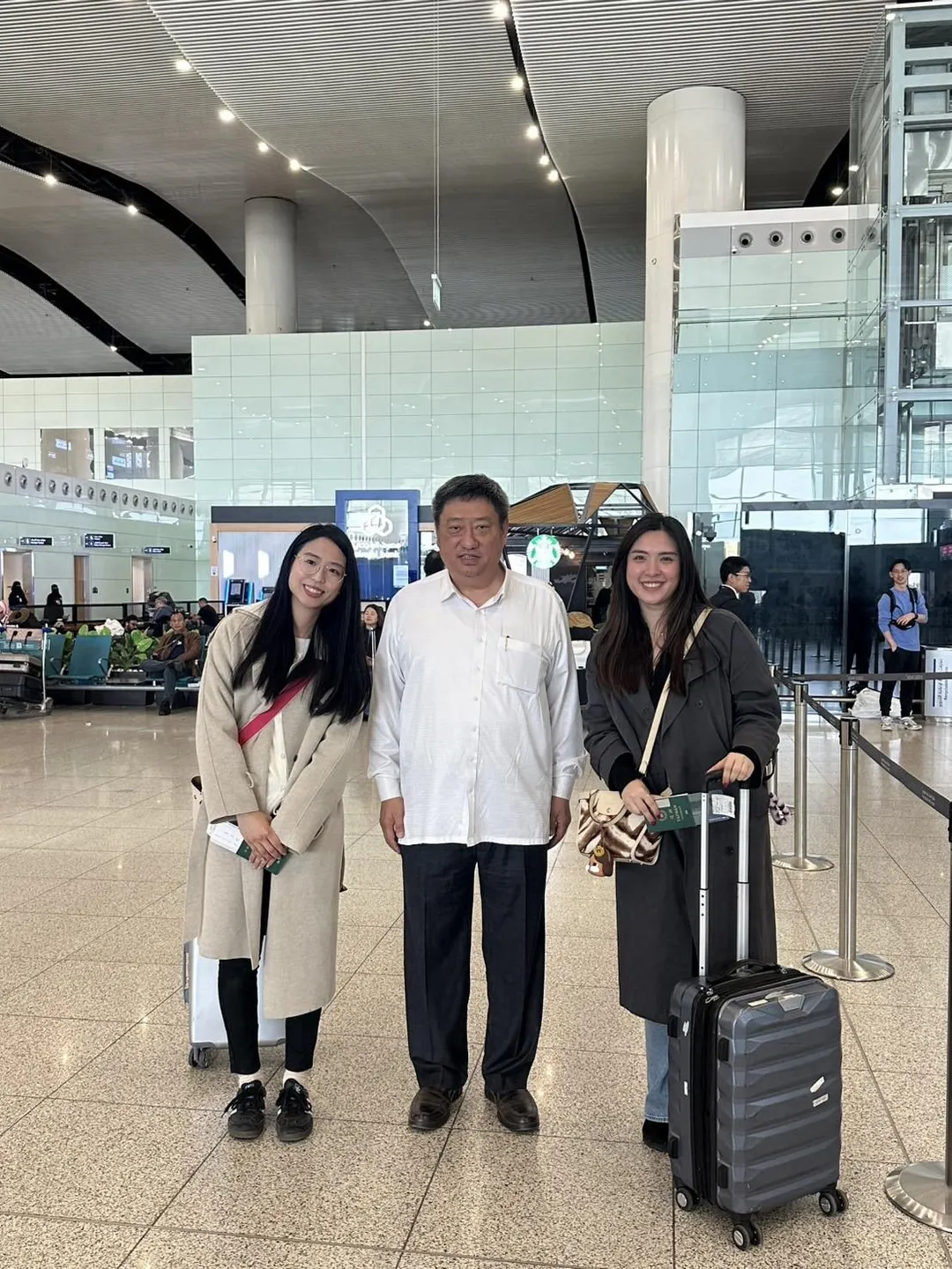 駐沙烏地阿拉伯代表處代表張治平（中）與旅居巴林赴利雅德搭乘日本包機離境之國人。（圖／外交部）