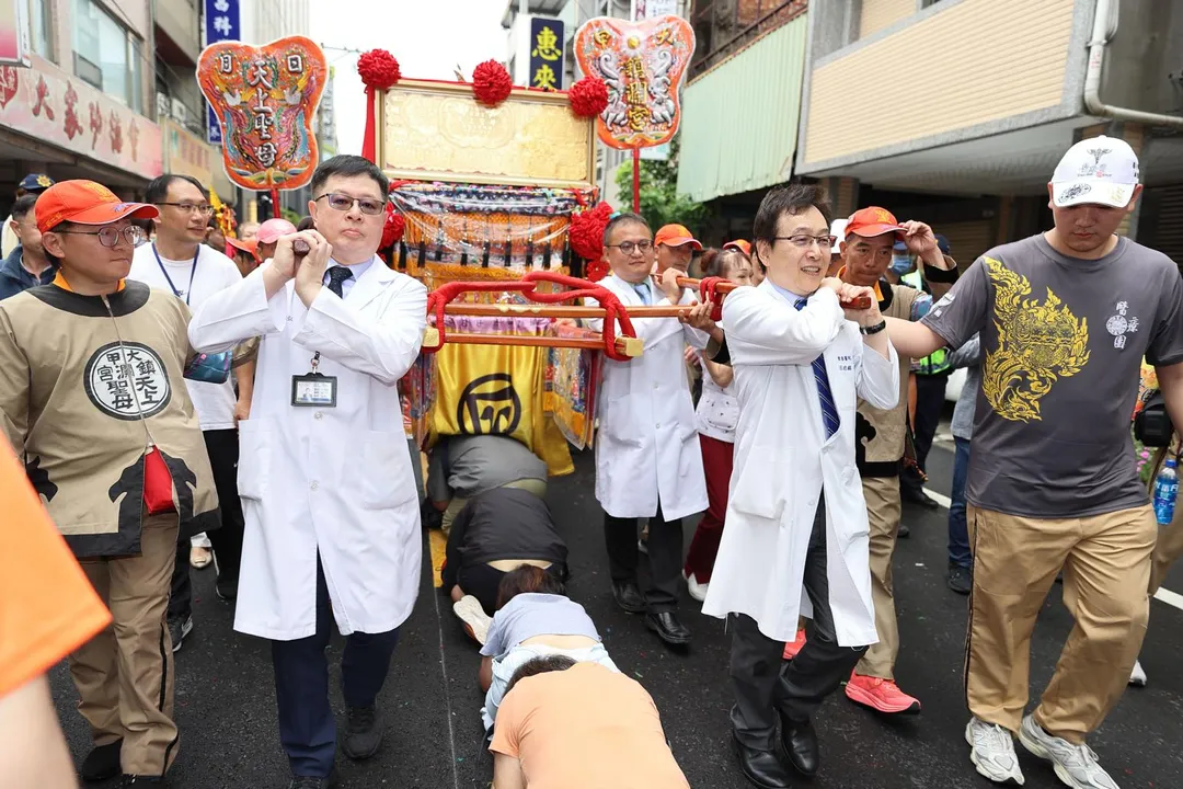 大甲媽祖遶境進香隊伍24日上午抵達員林市宏仁醫院，醫護人員親自扛轎為住院患者祈福。（圖／宏仁醫院）