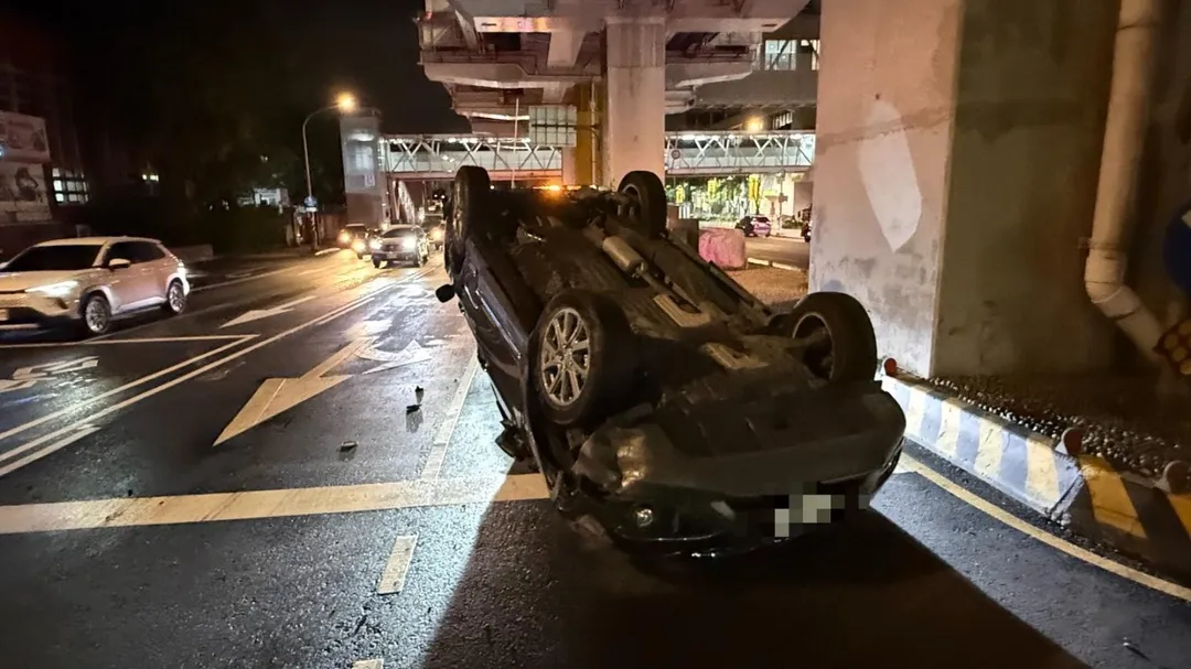 劉男駕駛的黑色轎車在猛烈撞擊後失控翻滾,最後底朝天翻覆於路中央。(圖/警方提供)