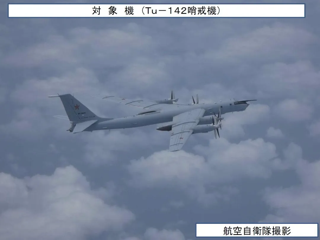 空自拍攝的俄國Tu-142巡邏機,顯示日本戰機在其右上方飛行監控。(圖/防衛省)