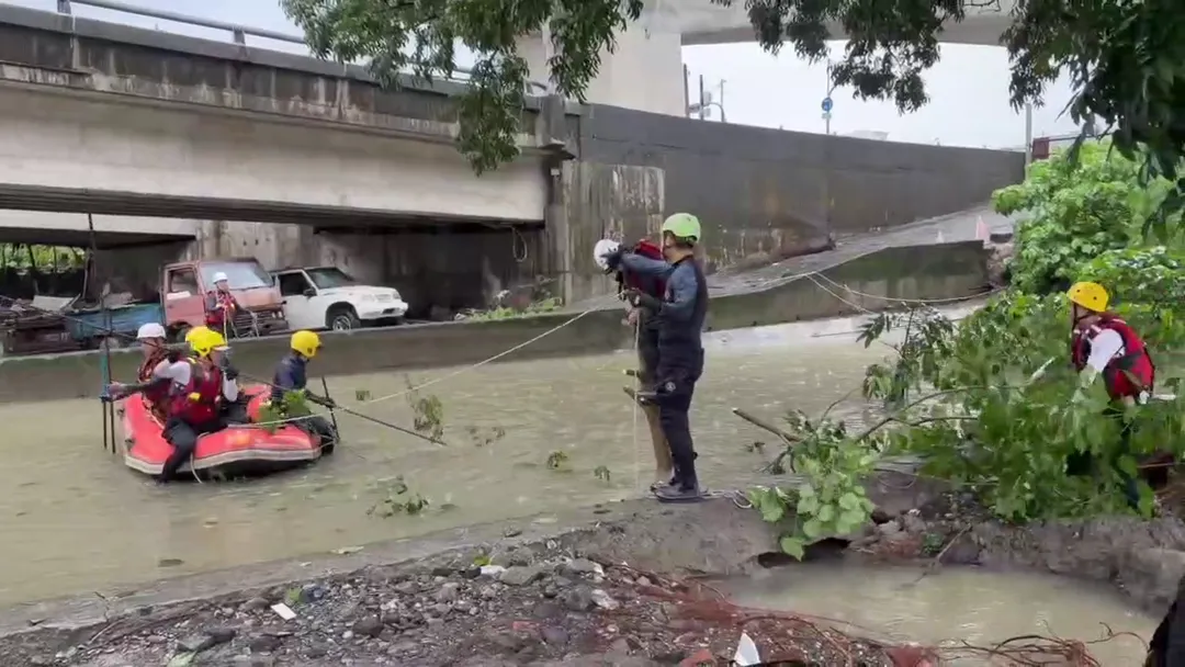 屏東縣萬丹鄉台88線橋下因豪雨導致麟洛溪水漫過路面，搜救人員趕赴現場掌握淹水狀況。（圖／中天新聞）