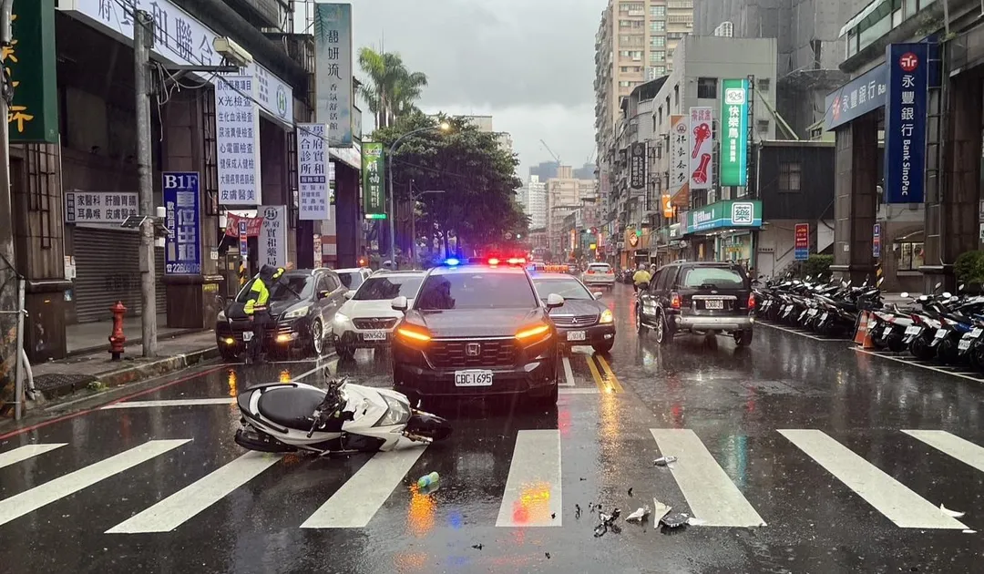 機車打滑擦撞車輛零件散落一地。（圖／翻攝畫面）