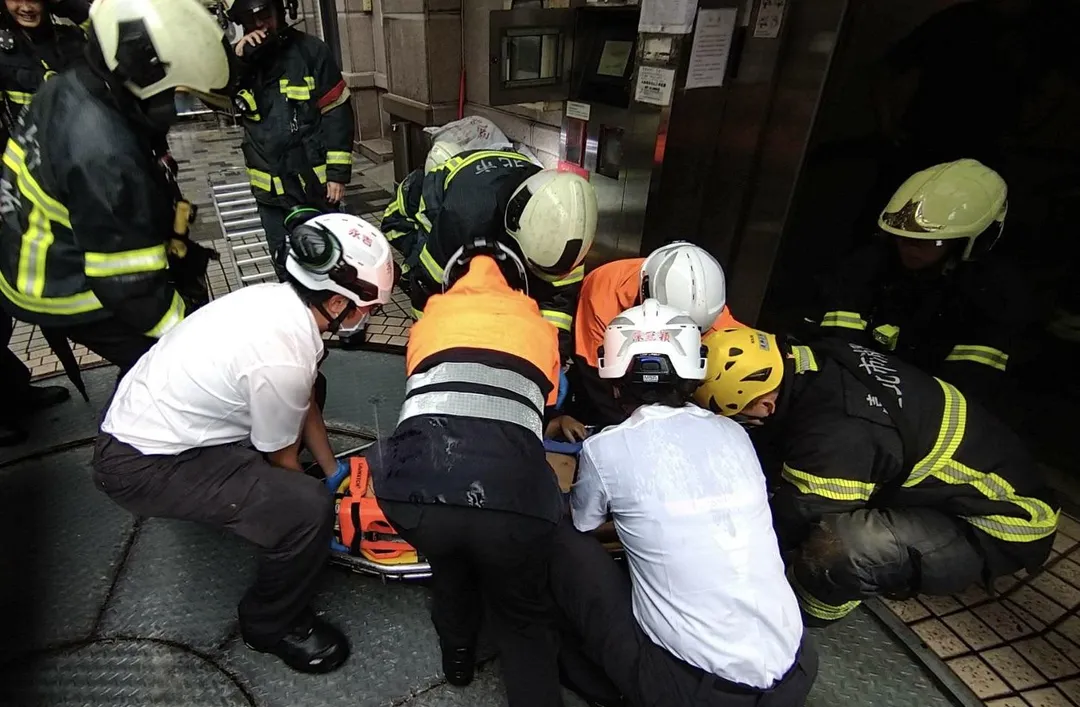 60多歲保全被救出時已無生命跡象，救護車緊急送醫搶救。（圖／中天新聞）