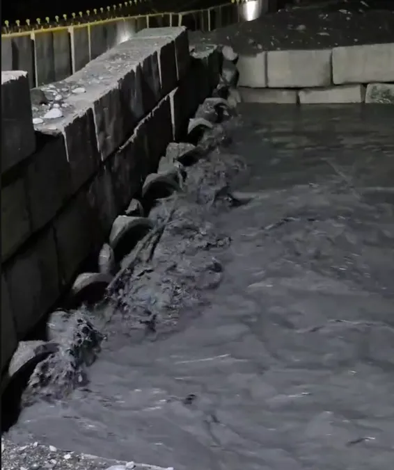 新堰塞湖泥水夾帶雜木奔流，堵住部分涵管。（圖／中天新聞）