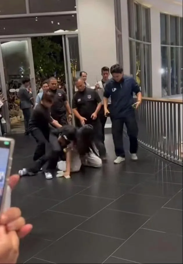 大陸女粉絲被保全壓制在地。(圖/翻攝微博)