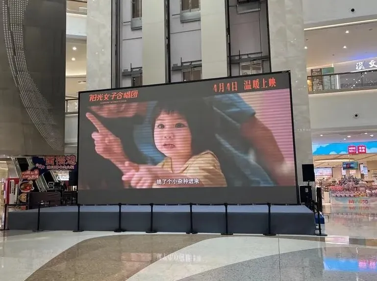 電影《陽光女子合唱團》4日在中國大陸正式上映，上海一家商場透過大螢幕宣傳電影。（圖／中央社）