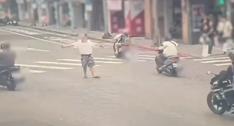 台北市南港路一段有男子疑似酒醉站在車道中央攔車。（圖／警方提供）
