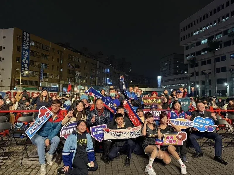 世界棒球經典賽資格賽（WBCQ）中華隊25日決戰西班牙隊，桃園市政府晚間在府前廣場舉辦直播活動，市長張善政（2排左3）與在場民眾一同應援，大批民眾到場替中華隊球員加油集氣，場面熱鬧。（圖/中央社）